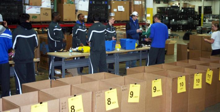 Men's Basketball helps Soles for Jesus package shoes for Africa